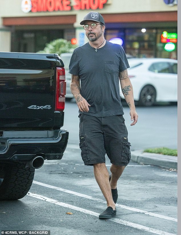 The former Nirvana drummer wore a casual outfit for the outing, featuring a gray T-shirt, black cargo shorts and a baseball hat.