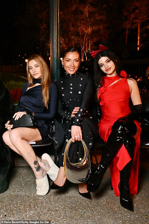 Paris posed for the cameras and completed her outfit for the evening with a black handbag (pictured with Georgina Mazzeo and Fabiola Baglieri)