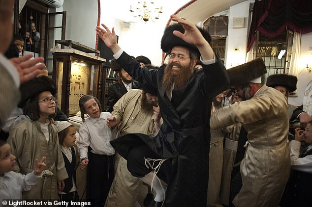 A man dances in a synagogue during the celebration of Simchat Torah