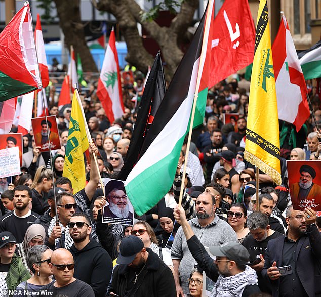 Small groups of young men, many masked, were seen at the rallies in each city waving the red and green flags of Hezbollah, a militant and political group originating in Lebanon that is listed as a terrorist organization in Australia.