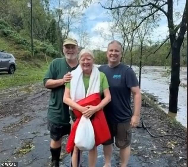 Worth and her husband Phil, center and left, lost all their belongings when their house fell into the water