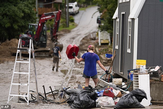 People clean up in the aftermath of Hurricane Helene on Tuesday, October 1, 2024 in Hot Springs, North Carolina