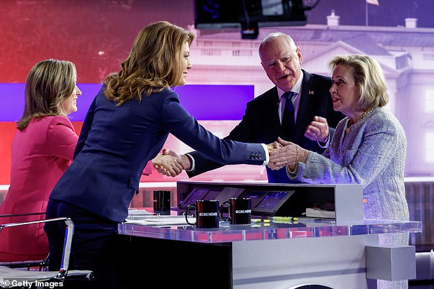 Democratic vice presidential candidate Minnesota Governor Tim Walz and his wife Gwen Walz greet moderators Margaret Brennan (far left) and Norah O'Donnell