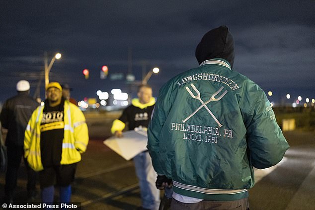 Philadelphia dock workers gathered outside the Packer Avenue Marine Terminal Port begin striking as their contracts expire at midnight, Tuesday, October 1, 2024. (AP Photo/Ryan Collerd)