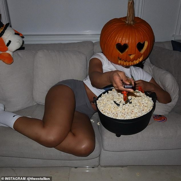 Megan also lay on a comfy couch with the pumpkin as she flipped through the channels on the television