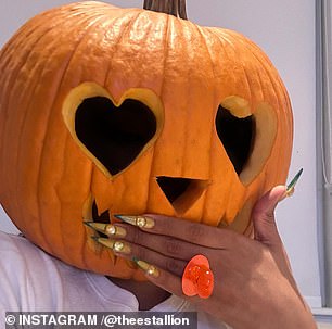 The star uploaded three selfies in the post as she showed off the carvings on the pumpkin and at one point held her hand over the whimsical mouth to show she was wearing an orange ring.