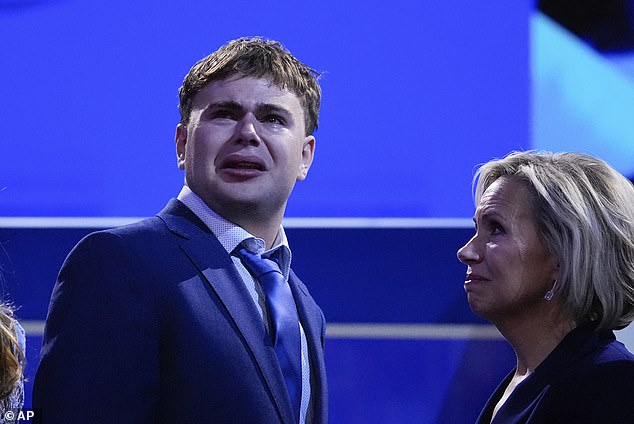 Gus Walz, son of Democratic vice presidential candidate Minnesota Governor Tim Walz, cries during the Democratic National Convention on Wednesday, August 21, 2024, in Chicago, as his mother Gwen Walz looks on