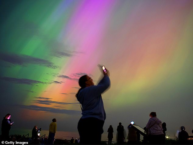 When charged particles from the Sun's coronal mass ejection hit Earth's atmosphere, their collision will produce the colorful lights we know are visible at lower latitudes. Pictured: Northern Lights over Whitley Bay, England, May 2024