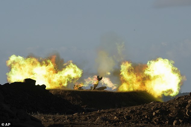 An Israeli mobile artillery unit fires a shell from the northern border towards Lebanon on Wednesday morning