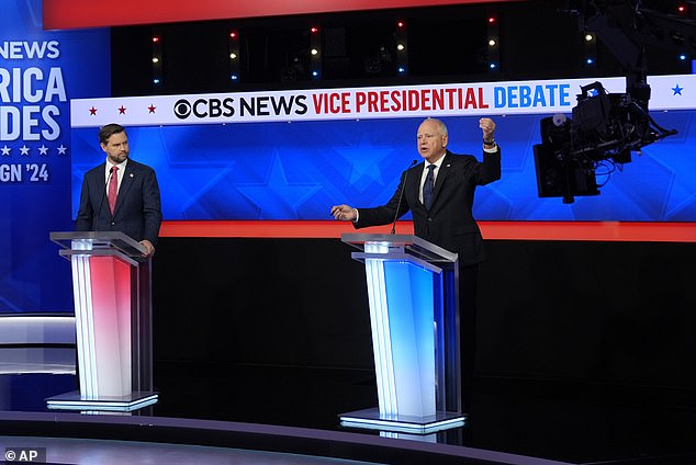 Democratic vice presidential candidate Tim Walz speaks with Republican vice presidential candidate Senator J.D. Vance during a vice presidential debate hosted by CBS News