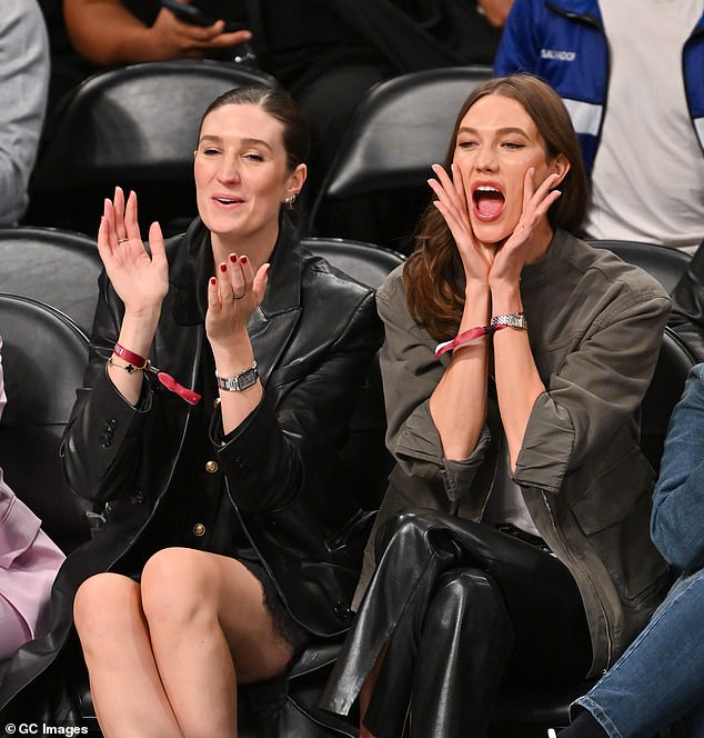 Karlie looked in good spirits as she sat courtside with a friend cheering on the teams