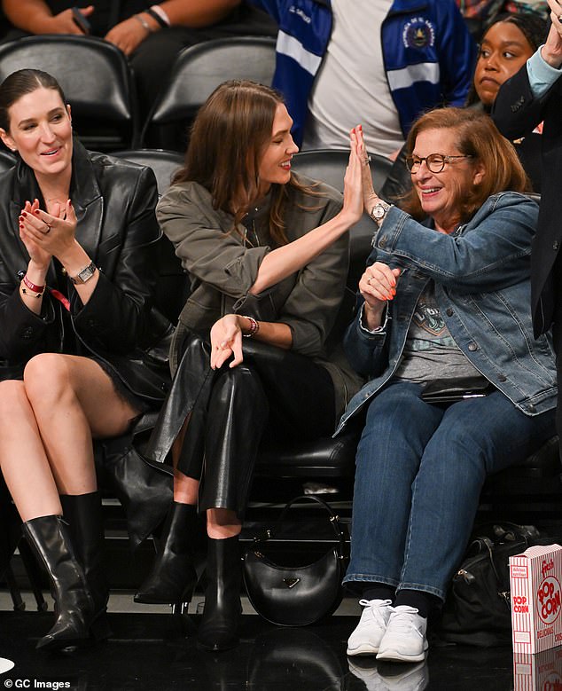 Before enthusiastically high-fiving other guests, who were also seated on the right, to watch the drama unfold