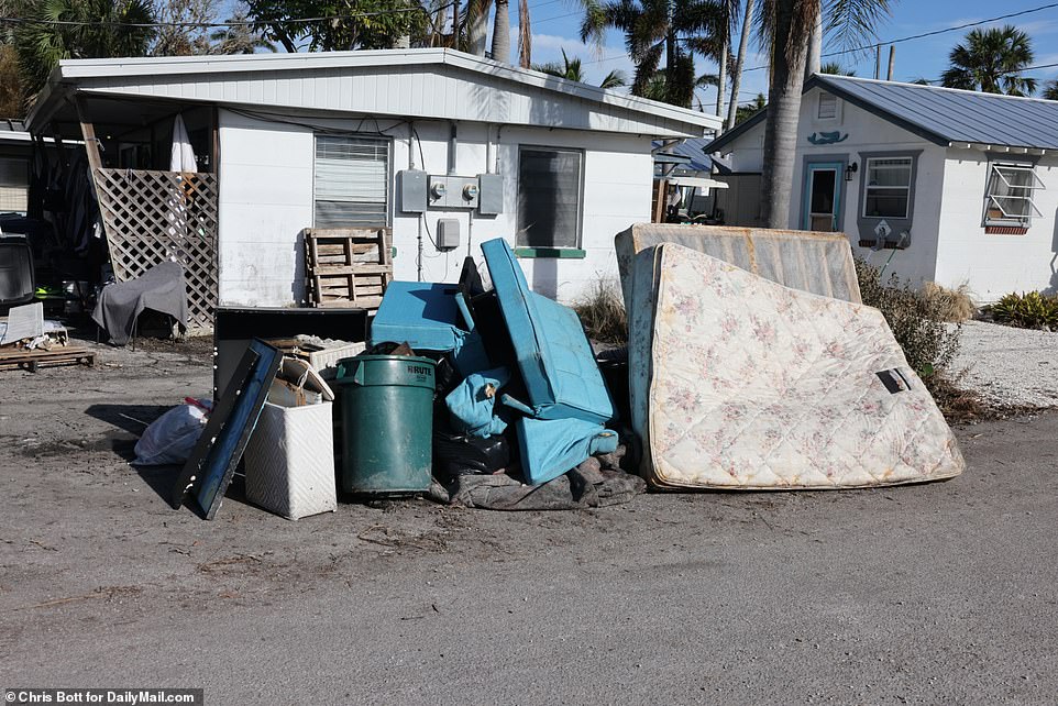 A mattress and other pillows lie outside a Cortez home in the wake of the storm surges