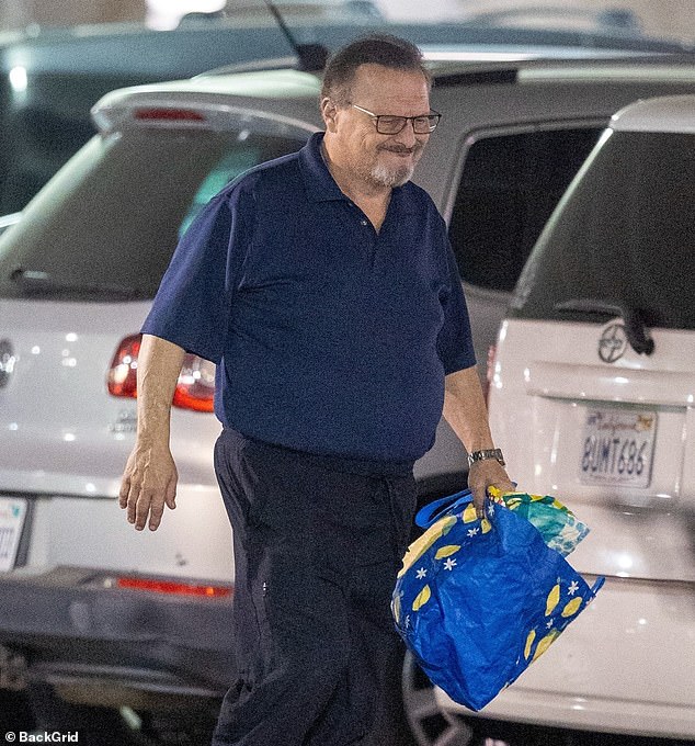 He was photographed walking through a parking garage