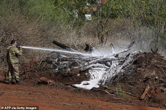 A firefighter uses foam to extinguish the fire in Hod HaSharon in the aftermath of an Iranian missile attack on Israel, on October 2, 2024