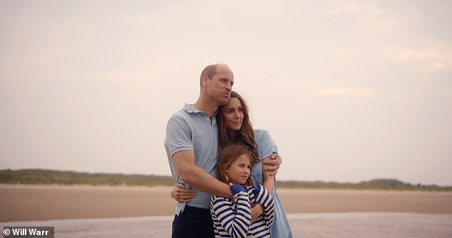 Princess Charlotte hugs their parents as they look out over a beach in Norfolk