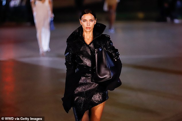 The supermodel, 38, walked the catwalk in a crocodile leather trench coat with a dramatic collar as she took part in the star-studded show