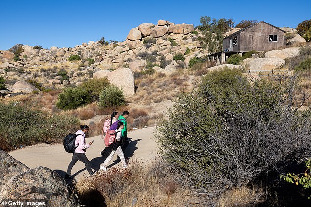 The researchers noted that teenagers in particular may be susceptible to psychosis due to increased exposure to traumatic events and losing friends and other social networks (photo: Colombian asylum seekers walk through the desert after crossing the US and Mexico near Jacumba Hot Springs , California)