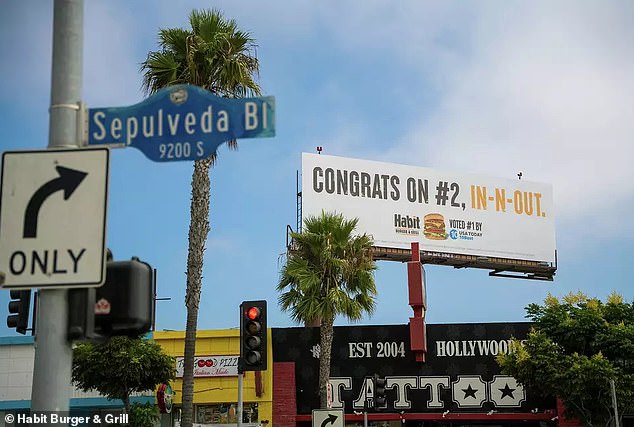 The specific ad is above a tattoo parlor on Sepulveda Boulevard, directly across the street from an In-N-Out