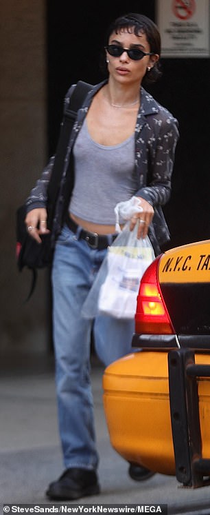 Kravitz went braless for the day's shoot in a low-cut gray tank top and baggy blue jeans