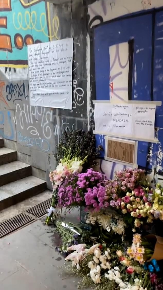 Floral tributes have since appeared at the site of the tragedy – in Tbilisi's Republic Square – next to a sign in English stating that the height of the wall meets building regulations.