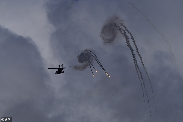 An Israeli Apache helicopter fires flares near the Israel-Lebanon border