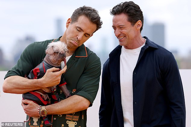 Cast members Hugh Jackman and Ryan Reynolds hold Britain's ugliest dog Peggy