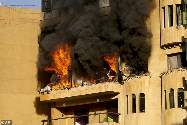 Flames rise from an apartment that caught fire after an Israeli airstrike in Dahieh, Beirut, Lebanon, Wednesday, October 2, 2024