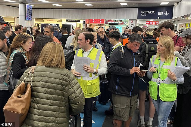 Passengers wait for their flights at Orio al Serio airport after Milan-Bergamo airport was closed due to the incident