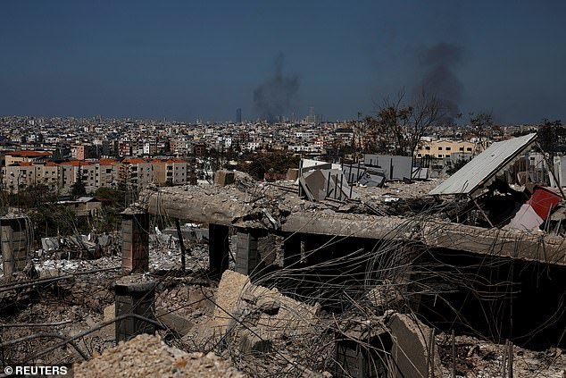 A look at the damage caused by previous Israeli airstrikes as smoke rises over Beirut's southern suburbs