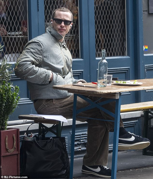 Joseph cut a casual figure for his solo lunch in a padded green jacket and brown pants