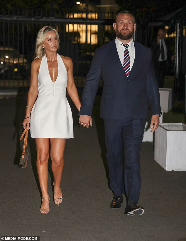 Jared Waerea-Hargreaves' wife Chelsea opted for a white halter-neck dress with a plunging neckline that showed off her statement assets. She wore a Louis Vuitton clutch and heels with gemstones on the straps. Both shown