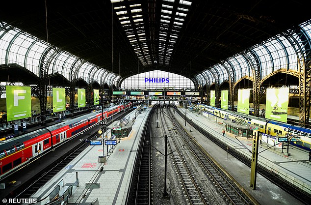 Police cordoned off tracks seven and eight at Hamburg station for several hours and travelers were cleared from the platforms after emergency services boarded the ICE from Frankfurt in full protective suits amid fears two passengers may have had the Marburg virus