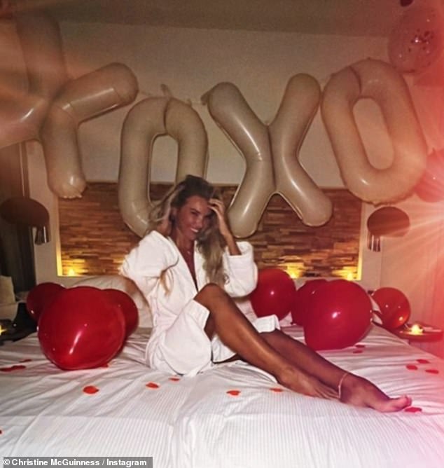 She shared a slew of snaps from her trip to Ibiza, including her lounging on a bed strewn with rose petals, candles and balloons, but her companion remained a mystery.