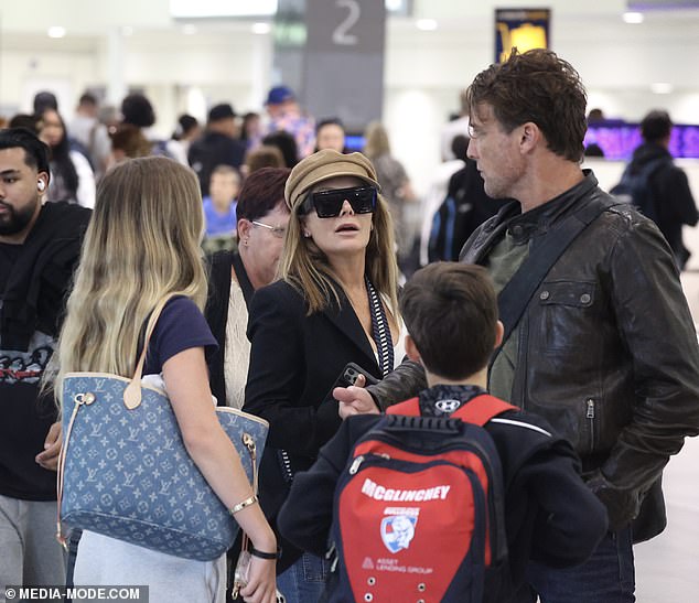 Natalie, 50, and Cameron, 49, were spotted at Sydney Airport on Thursday with their two children Harper, 14, and Hendrix, 11