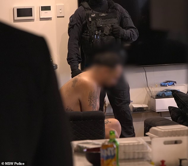 Bargshoon in custody after his arrest by heavily armed police from the State Crime Command Organized Crime Squad, who dragged him out of the unit in only his underwear