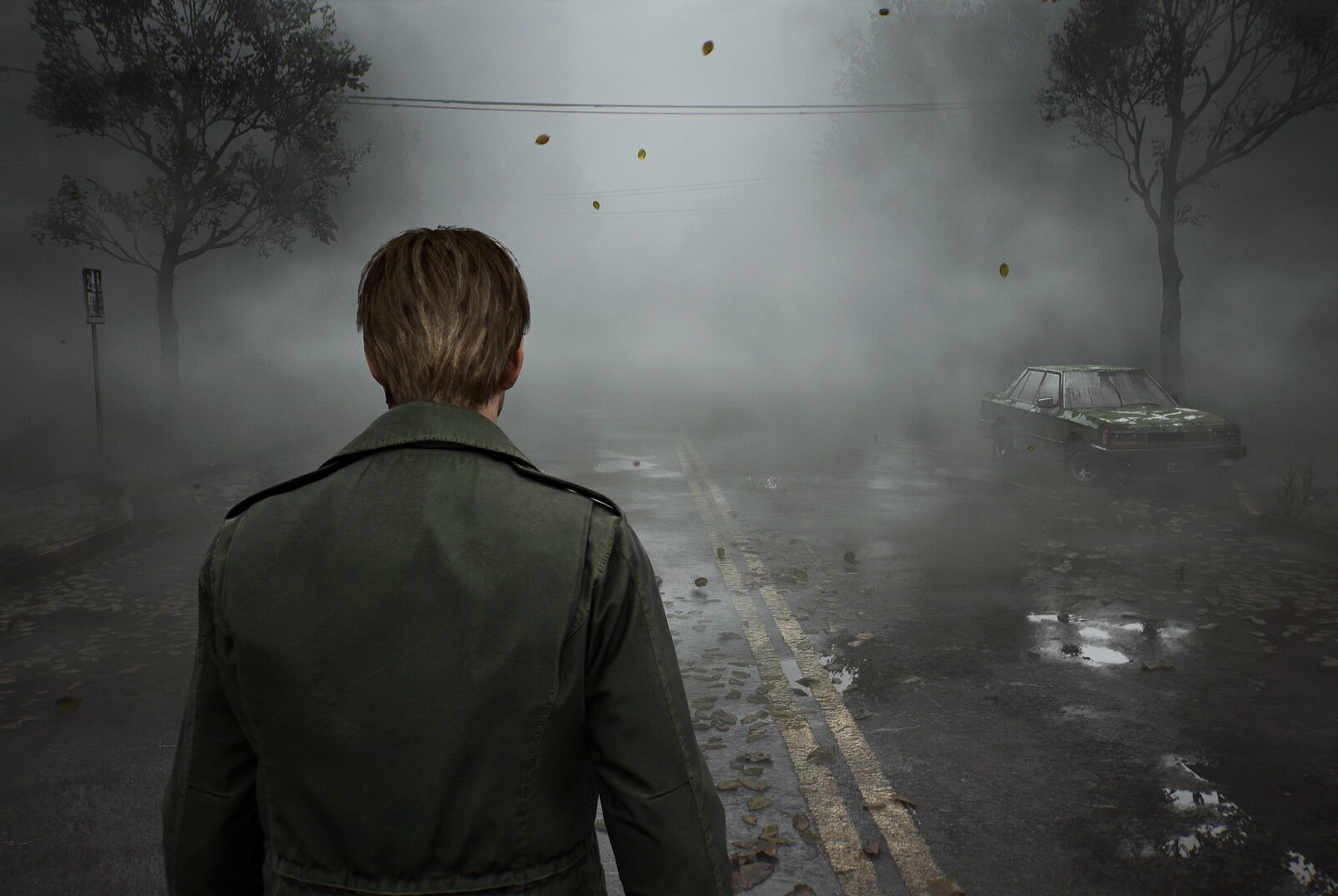 James, the main character of Silent Hill 2, looks away from the viewer towards a very foggy street