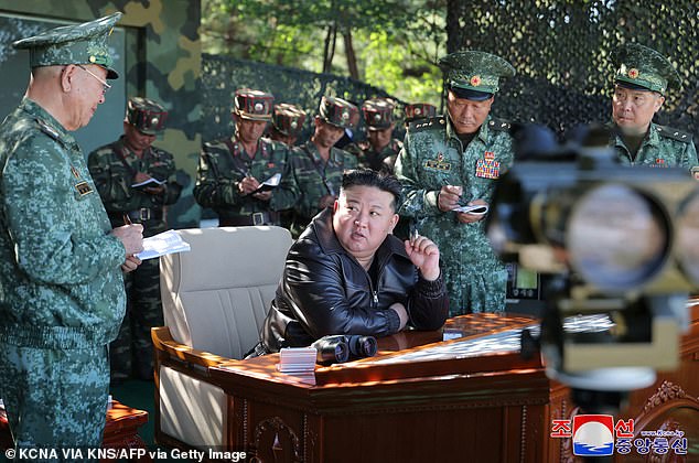 Kim Jong Un speaks with military officials at a special forces training base in North Korea's western region