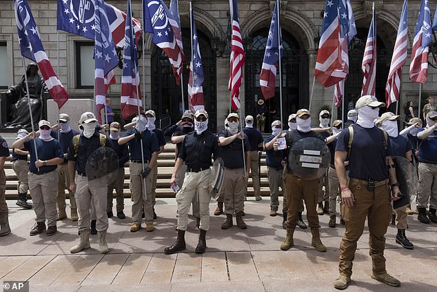 The group is pictured in front of the Boston Public Library holding flags, near where Murrell was attacked