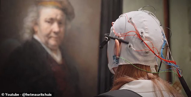 The scientists found that people's emotional responses were ten times more powerful when they looked at real art than when they looked at posters. In the photo: a research participant examines art in the Mauritshuis where 'Girl with a Pearl Earring' is held