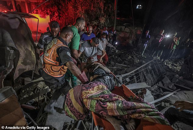 Civil Defense members rescue injured people from the rubble of a building after Israeli strikes hit the Jaber family home in Deir Al Balah, Gaza, on October 4, 2024