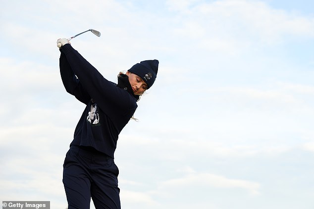 Dressed in a Ralph Lauren polo sweater with a bear print on the front and a matching blue pom-pom hat, Kathryn celebrated taking her game seriously as she swung her bat