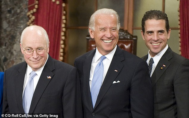 Vice President Dick Cheney, Vice President-elect Joe Biden, and his son Hunter Biden pose for photos after Senator Biden's mock swearing-in ceremony as U.S. Senator