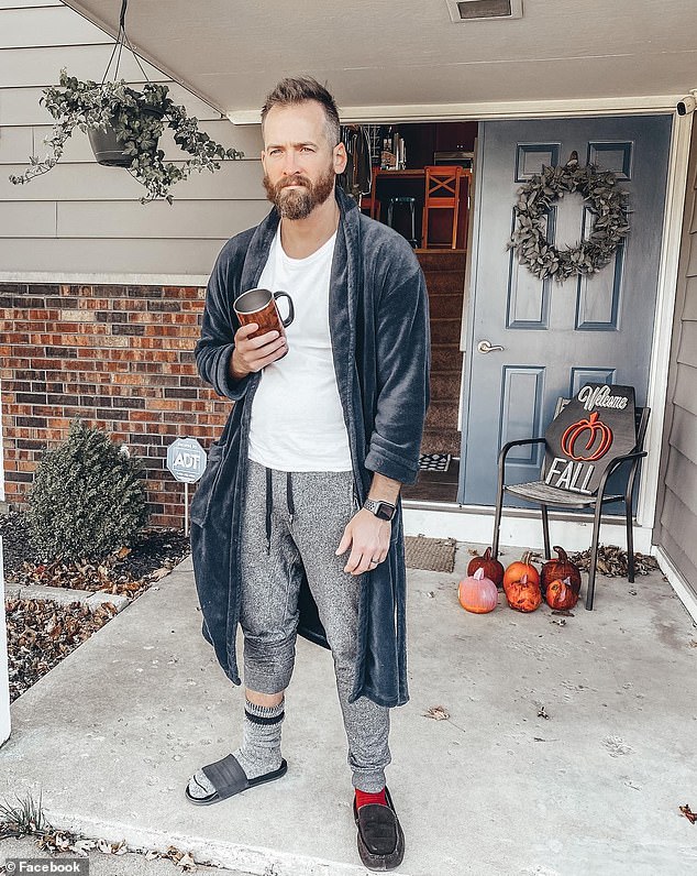 Mills pictured in a bathrobe with sweatpants and a T-shirt in matchless socks and slippers with a mug in his hand