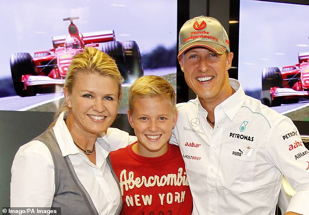 Mick – pictured with mother Corinna (left) and father Michael (right) – grew up in the racing world