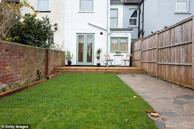 In Britain, backyards often have wooden fences and children's trampolines do not have British protection (stock image)