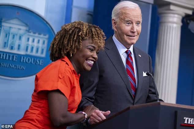 White House Press Secretary Karine Jean-Pierre (left) hugs President Joe Biden (right) during his surprise appearance at Friday's briefing