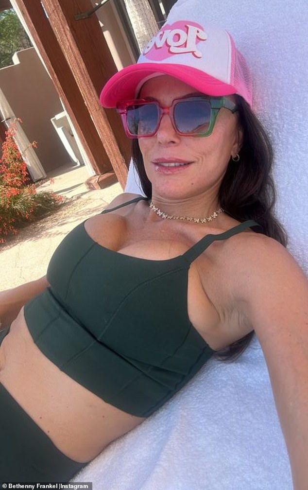 Frankel, 52, showed off her abs again in a second snap as she relaxed on a chaise longue, wearing a hunter green bra top and matching bottoms