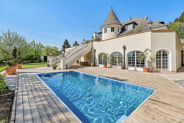 There is a further swimming pool outside in the large garden of the property with five beds