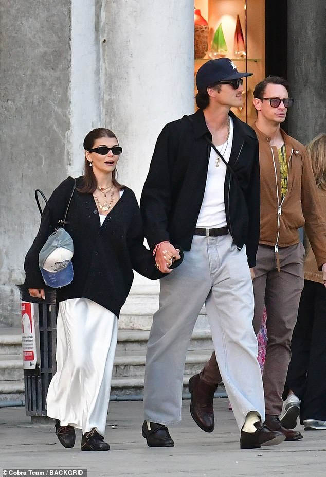 The couple also donned black jackets to board a boat that would take them to their next destination in the Italian city